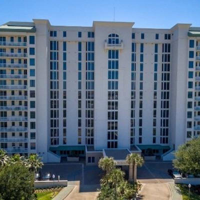 Exterior of the Silver Shells St. Lucia tower in Destin, Florida, with its private pool and landscaped grounds.
